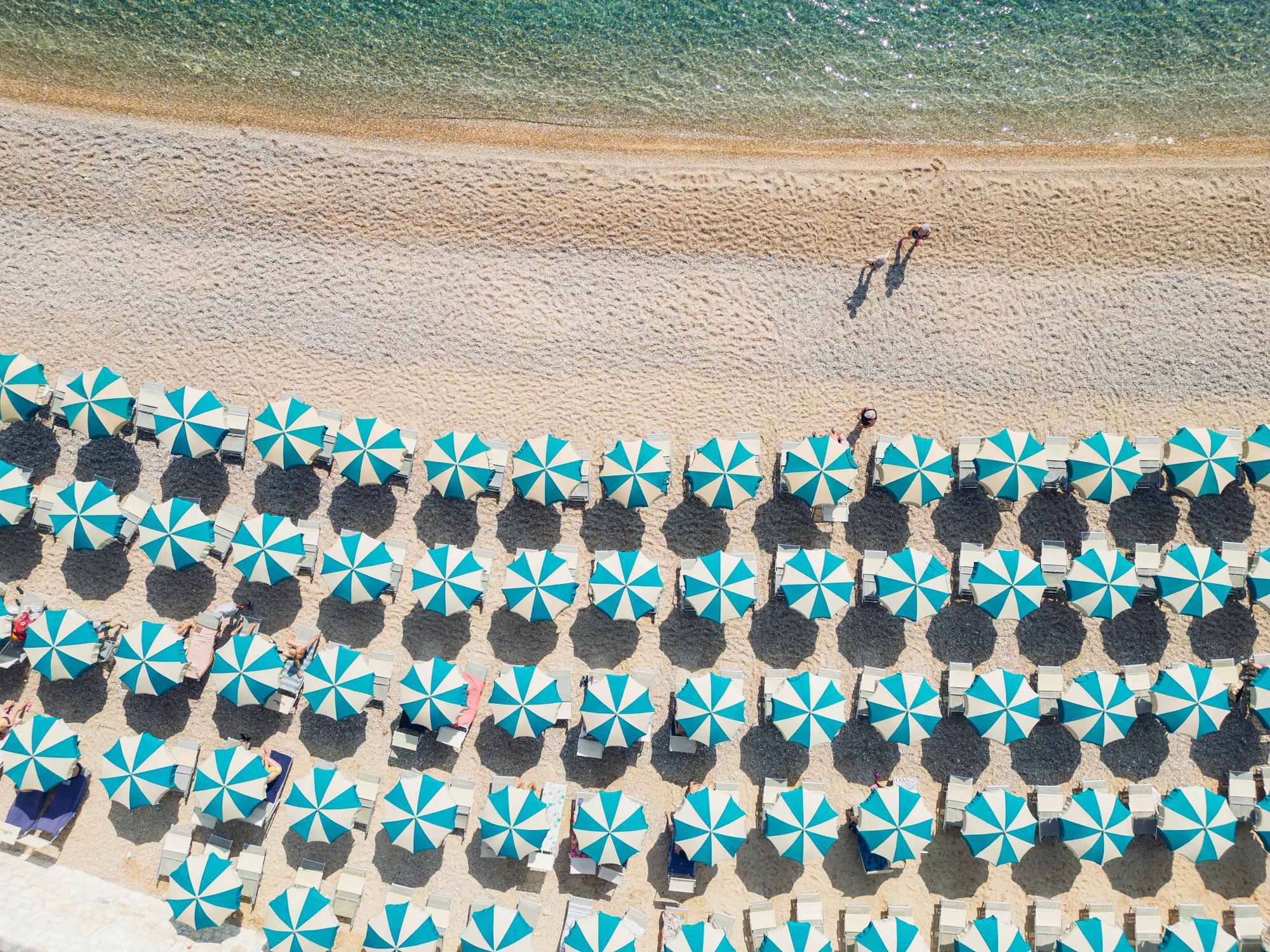 Italian coastline with beach umbrella rows