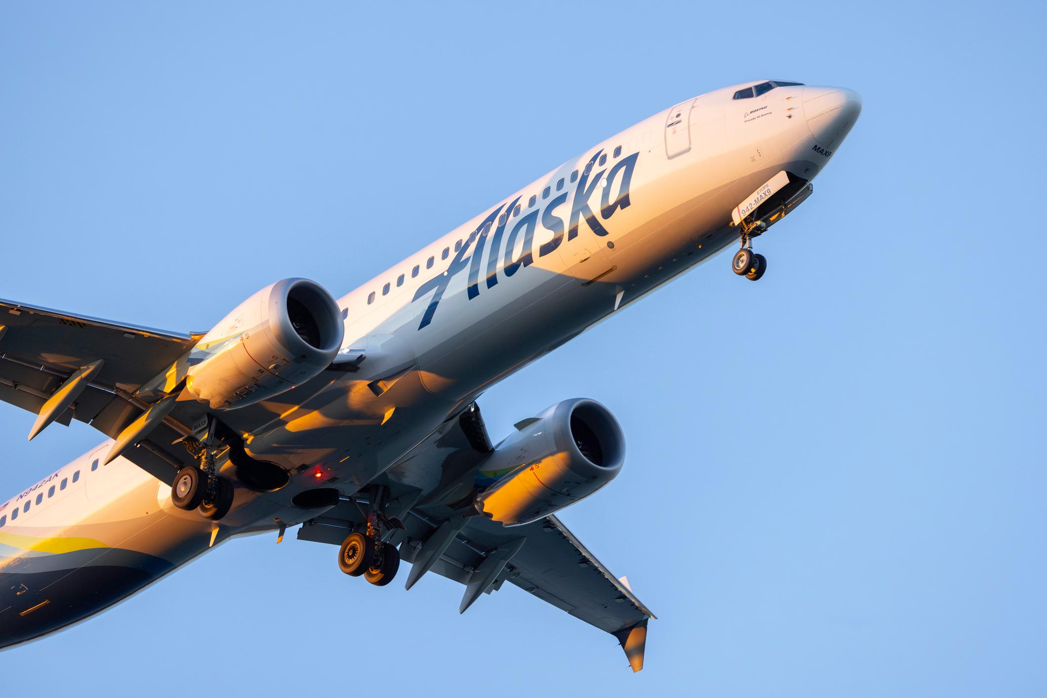 Portland, Oregon, USA - February 27, 2025: An Alaska Airlines 737 landing at PDX at sunset.