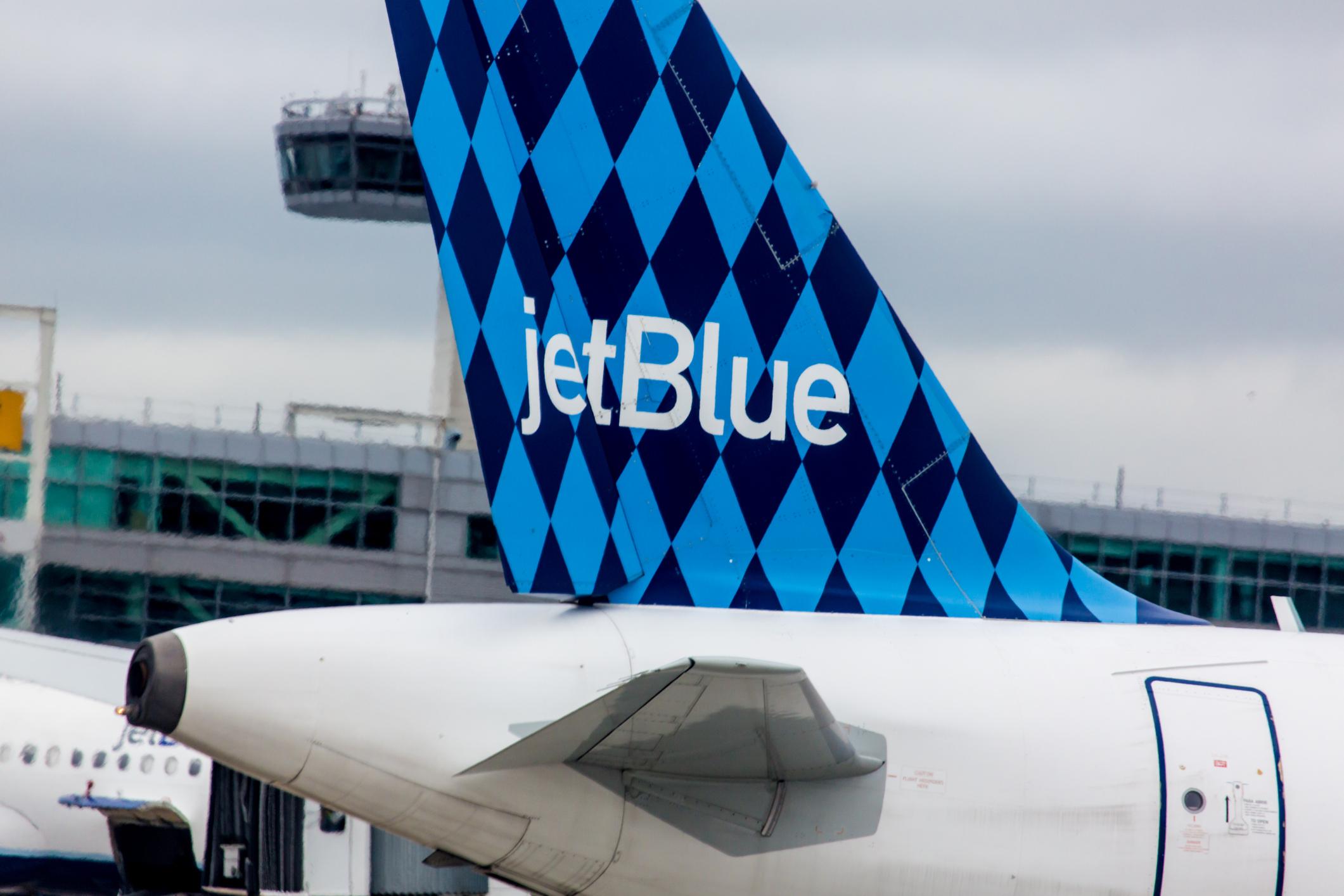 Airbus A320 JetBlue tailfin with Harlequinon design on John F. Kennedy International Airport in New York, NY on April 23, 2012. JetBlue aircraft features one of several tail designs. This diamond-studded pattern was created in 2000.