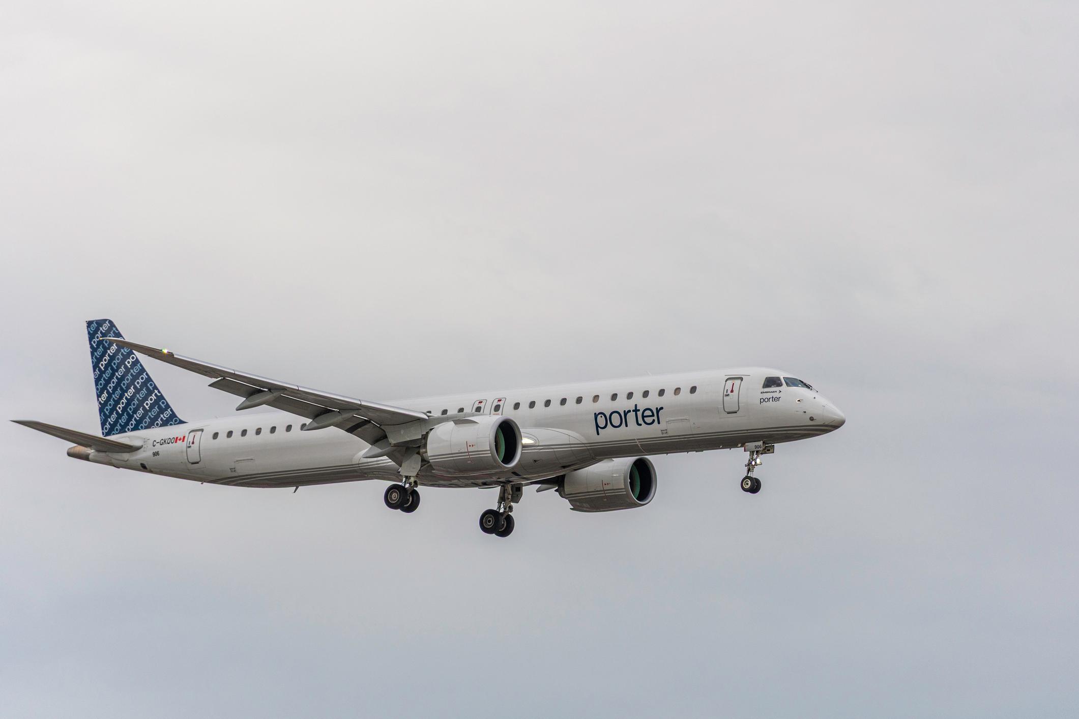 Porter Airlines Embraer E195-E2, registration C-GKQO and fleet number 906, photographed on final approach to Toronto Pearson International Airport in Toronto, Ontario, Canada, on September 15, 2026. The modern regional jet is shown with landing gear extended against an overcast sky. The aircraft is identified as an Embraer E195-E2 operated by Porter Airlines; fleet records list C-GKQO as aircraft 906.