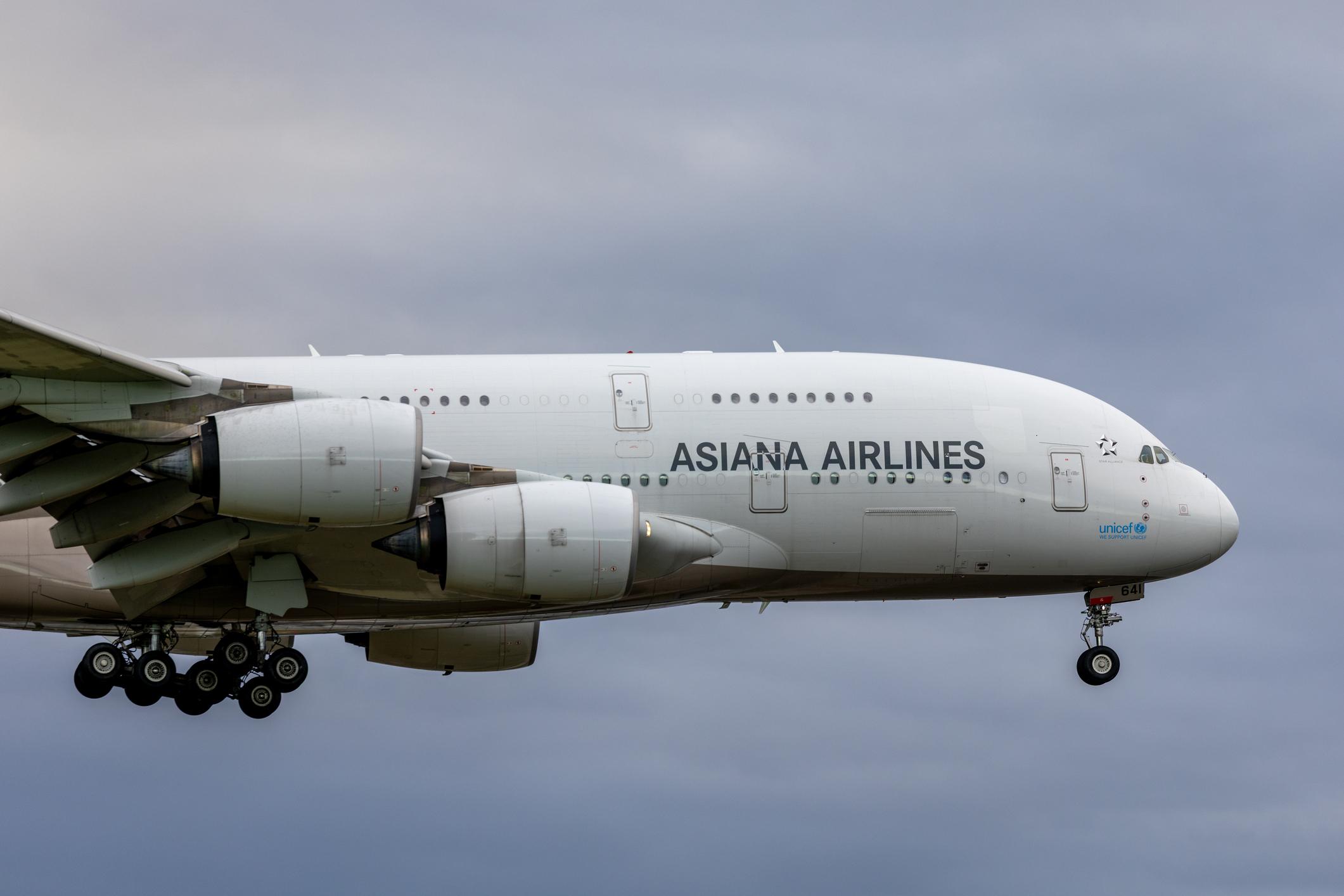 The forward fuselage and starboard wing of an Asiana Airlines Airbus A380-841 plane, registration HL7641, approaching to land on the main runway of Sydney Kingsford Smith Airport as flight OZ601 from Seoul. This image was taken from New Link Road, Mascot on a cold and overcast morning on 28 March 2026.