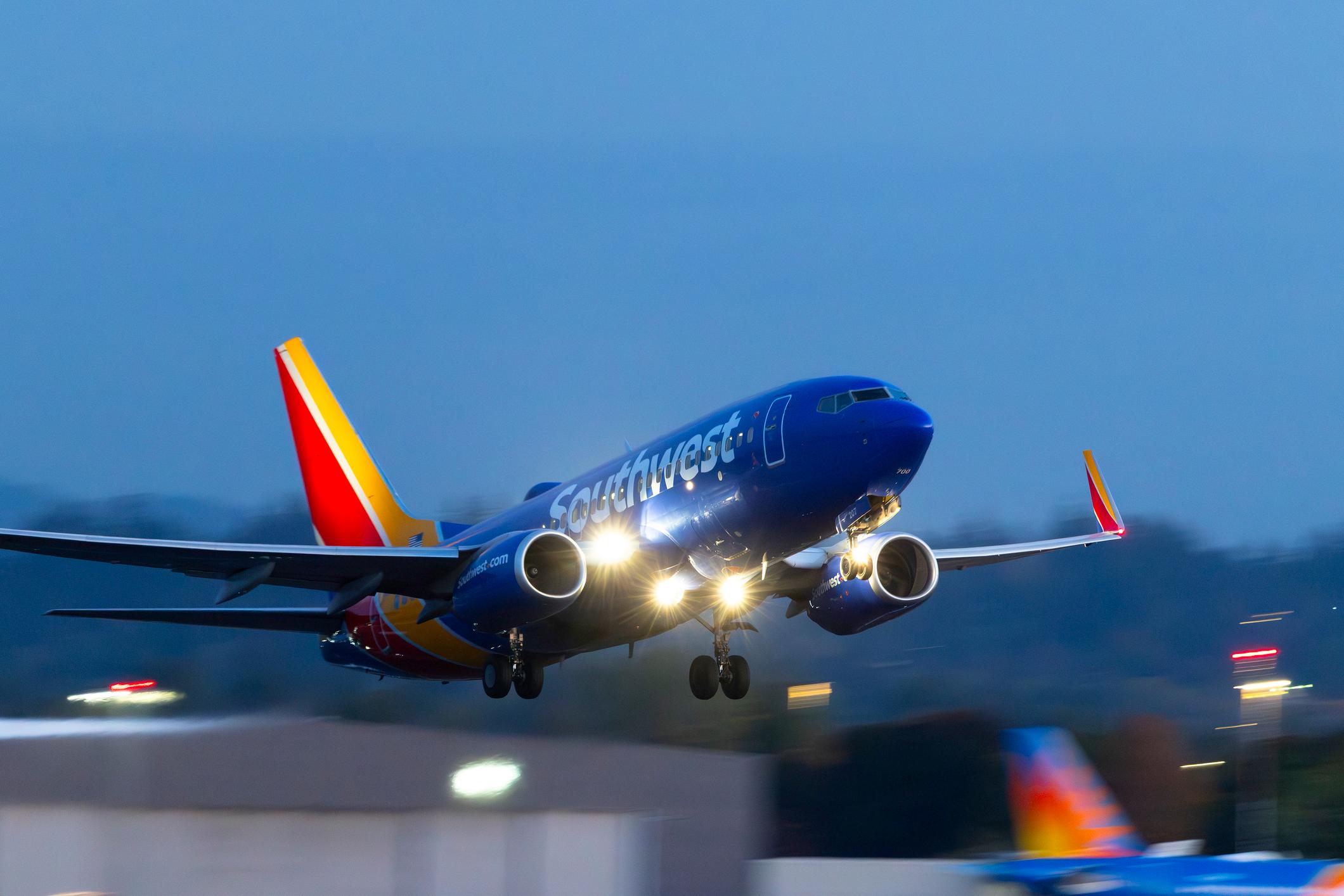 Portland, Oregon, USA - A Southwest 737, with landing lights blazing, departs Portland International at dusk.