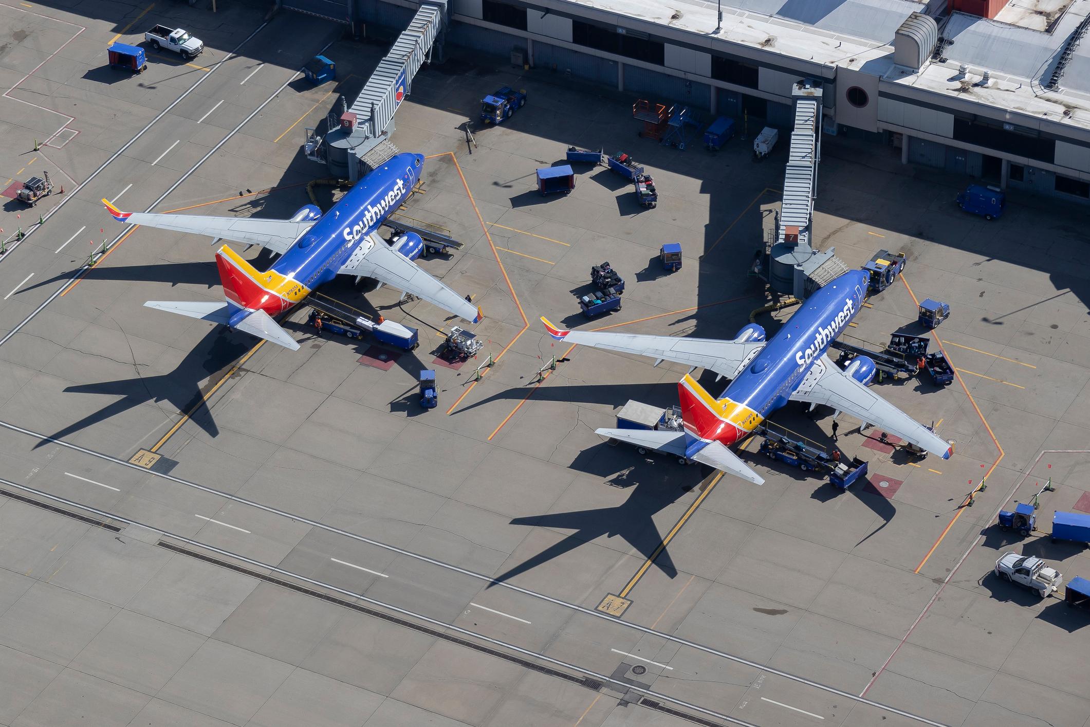 Two Southwest airline Boeing 737 passenger jets parked at terminal gates at Pittsburgh International airport Pittsburgh Pa photograph taken 2025
